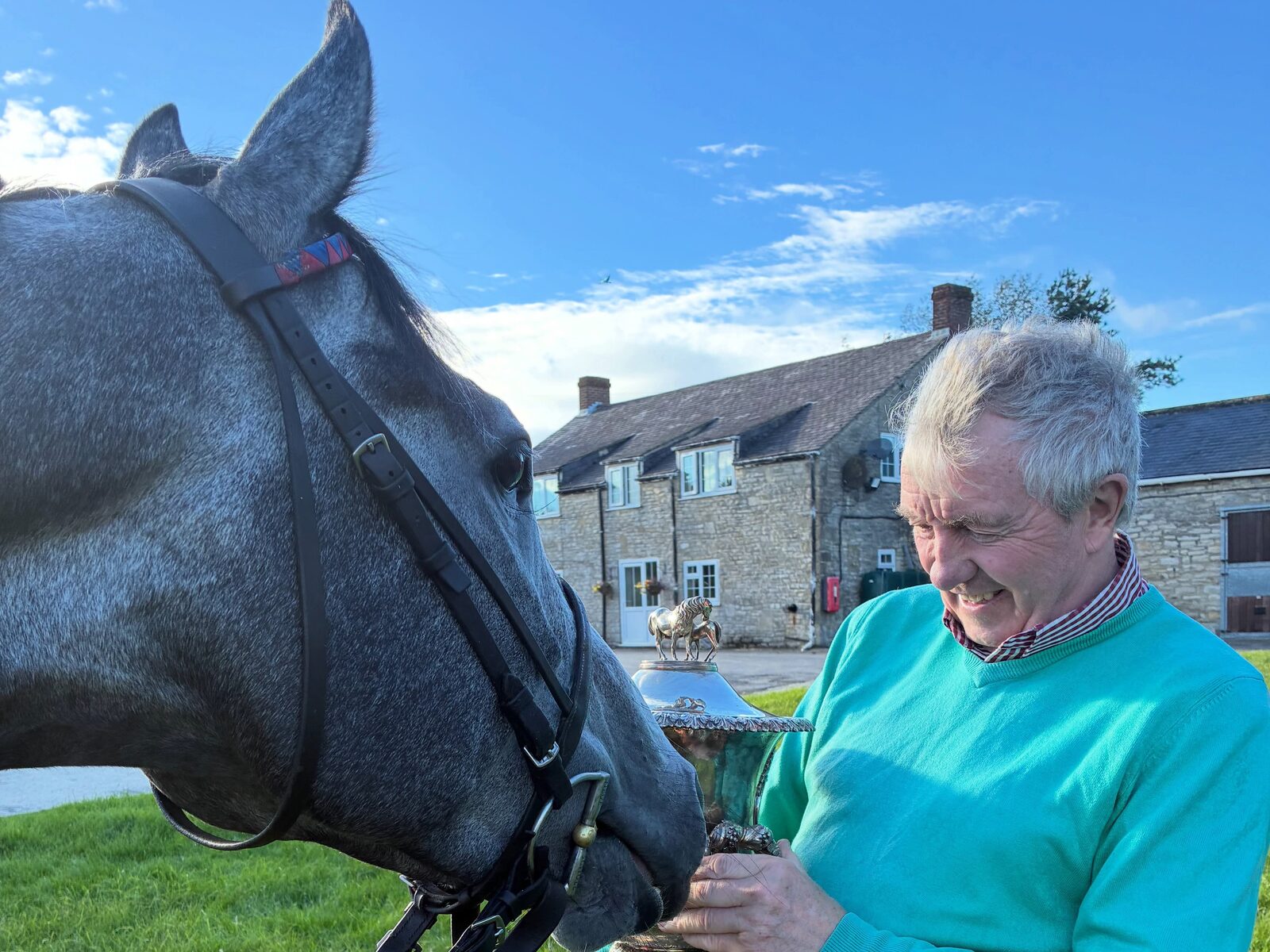 Close-up of Bryan Smart with Station X and the Silver Cup trophy at the Hambleton House yard.